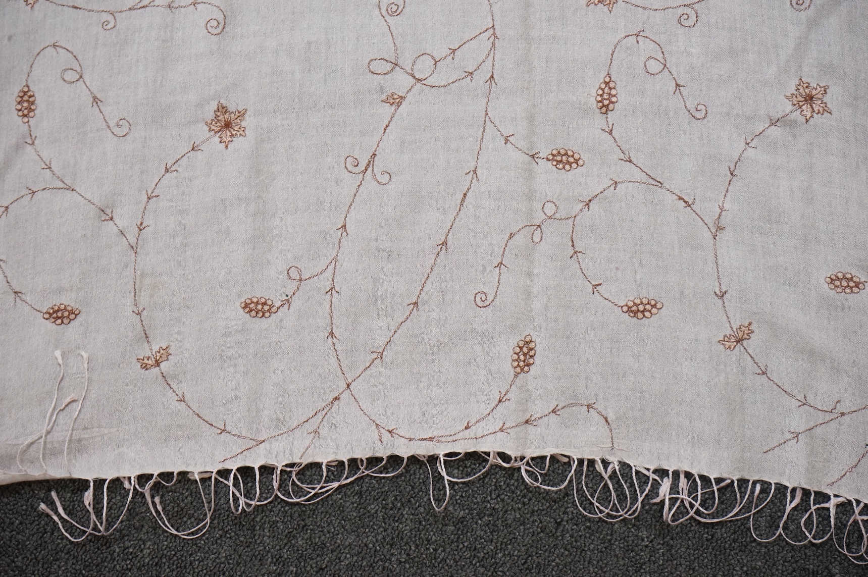 An Indian green and gold silk hand woven brocade stole, a cream pashmina embroidered stole and a similar finely woven and embroidered lilac stole (3). Brocade stole 38cm x 180cm., Condition - light stain to finely woven